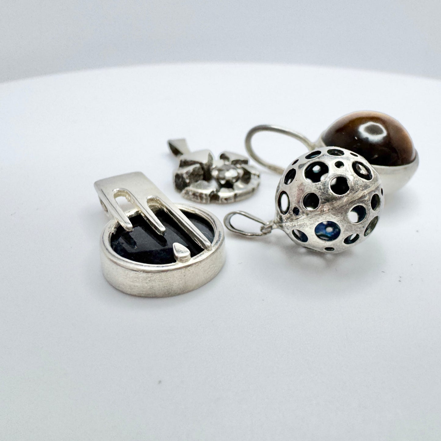 Finland. Four Small Vintage Solid Silver Pendants.