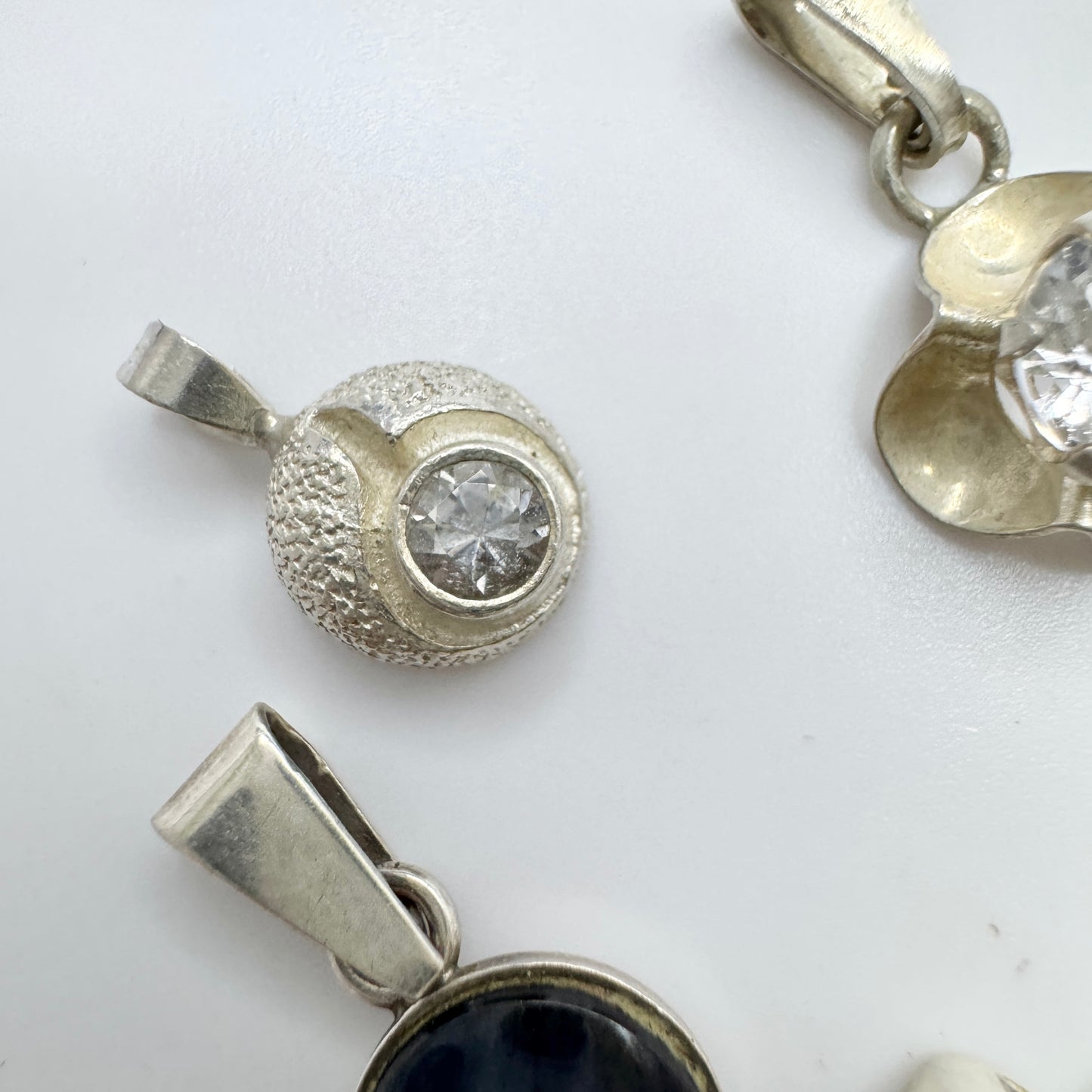 Finland. 4 Small Vintage Solid Silver Pendants.