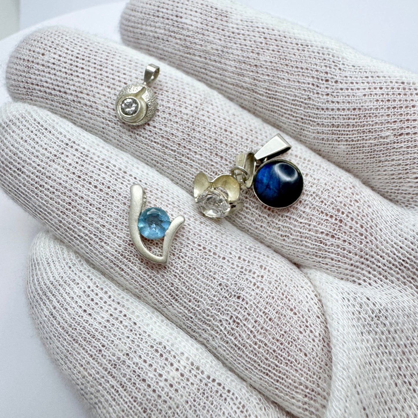 Finland. 4 Small Vintage Solid Silver Pendants.