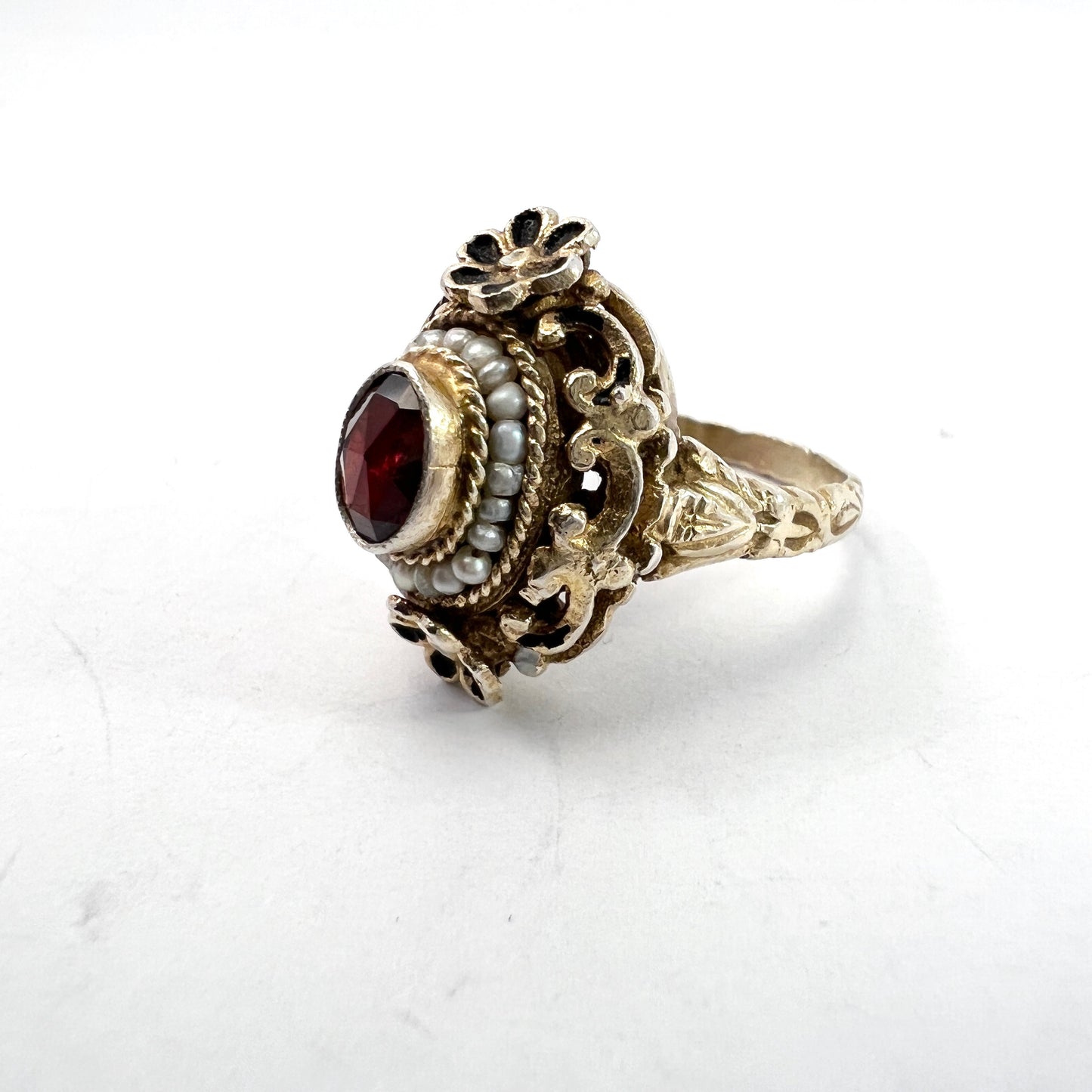 Austria-Hungary early 1900s. Antique Arts and Crafts Gilt 830 Silver Garnet Seed Pearl Enamel Ring.